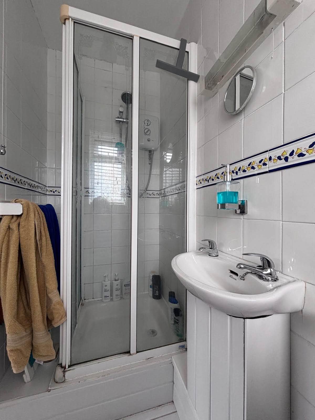 Existing tiled shower room before renovation